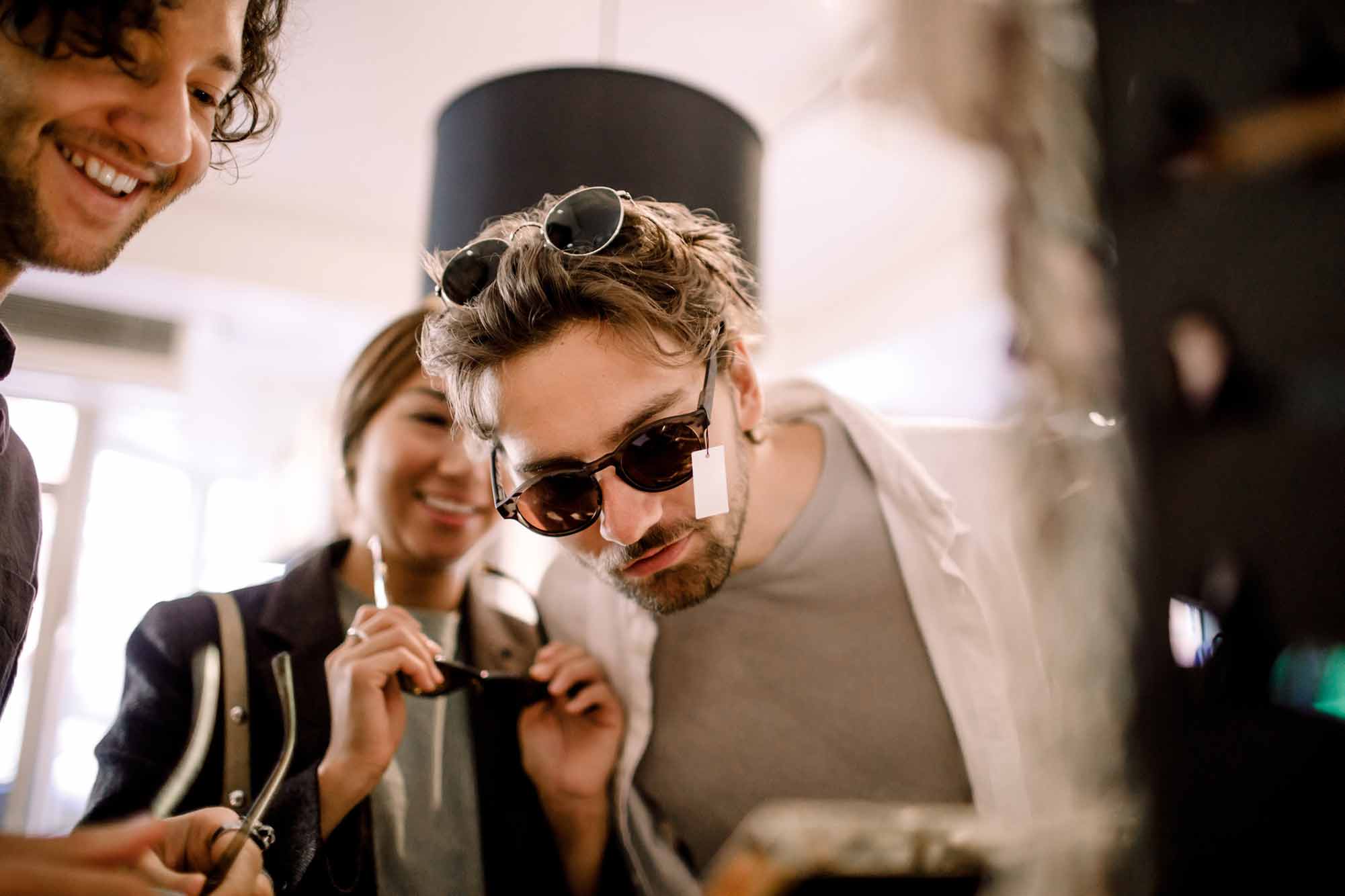 A person testing out sun glasses in a store.