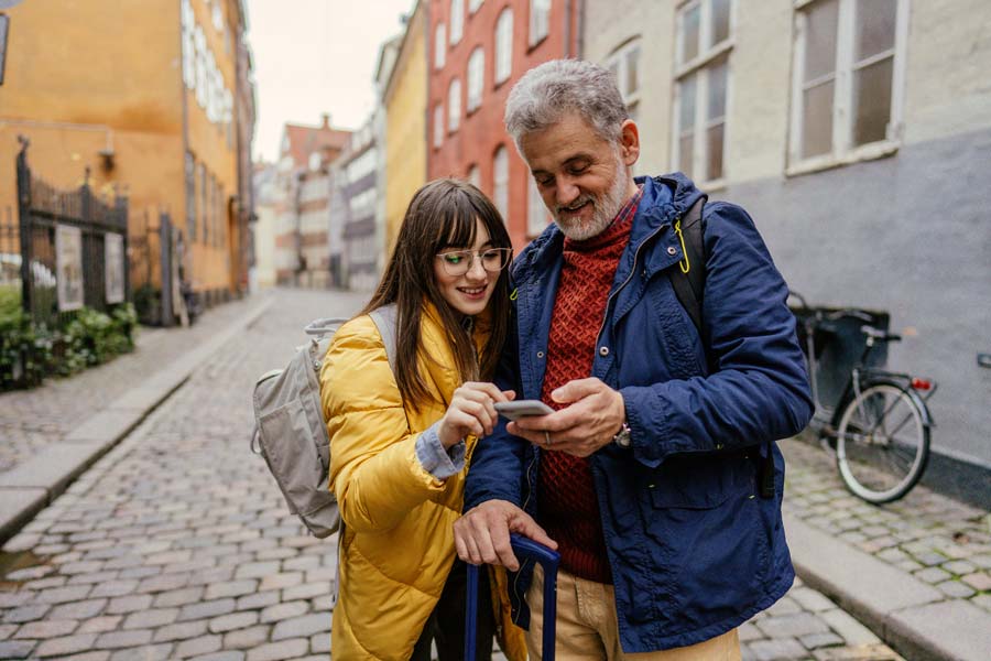 A man and a woman looking at a phone.