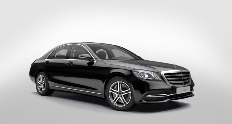 A black luxury limousine of the brand and model Mercedes Benz S.