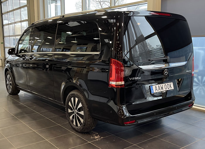 A black Mercedes Benz Van, also known as a luxury limousine.